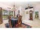 Charming dining area adjacent to the foyer featuring a chandelier and a large window with backyard views at 16730 Beauclaire Ct, Tavares, FL 32778