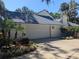Beautful home featuring a two-car garage, and mature landscaping in a residential neighborhood at 16730 Beauclaire Ct, Tavares, FL 32778