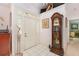Inviting foyer features tile flooring, a decorative statue, a grandfather clock, and ample natural light at 16730 Beauclaire Ct, Tavares, FL 32778