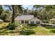 Charming single-story home featuring mature landscaping and a well-maintained front yard, with a screened in porch at 16730 Beauclaire Ct, Tavares, FL 32778