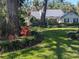 The front of the house shows mature trees and landscaping around the property at 16730 Beauclaire Ct, Tavares, FL 32778