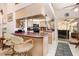 Bright kitchen with sleek appliances, bar seating, and sliding glass doors leading to the outdoor patio at 16730 Beauclaire Ct, Tavares, FL 32778