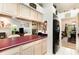 Open kitchen featuring cream cabinets and a breakfast bar looking into the living area at 16730 Beauclaire Ct, Tavares, FL 32778