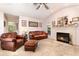 Inviting living room with a fireplace and leather seating at 16730 Beauclaire Ct, Tavares, FL 32778