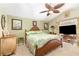 Comfortable main bedroom featuring a unique bed frame and decorative ceiling fan at 16730 Beauclaire Ct, Tavares, FL 32778