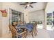 Inviting covered patio featuring a dining table and comfortable seating at 16730 Beauclaire Ct, Tavares, FL 32778