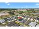 Beautiful home in a picturesque community with ponds and lush landscaping seen from an aerial view under a blue sky at 1674 Cadorette Dr, The Villages, FL 34762