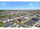 Beautiful home in a picturesque community with ponds and lush landscaping seen from an aerial view under a blue sky at 1674 Cadorette Dr, The Villages, FL 34762