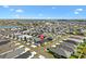 Beautiful home in a picturesque community with ponds and lush landscaping seen from an aerial view under a blue sky at 1674 Cadorette Dr, The Villages, FL 34762
