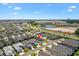 Beautiful home in a picturesque community with ponds and lush landscaping seen from an aerial view under a blue sky at 1674 Cadorette Dr, The Villages, FL 34762