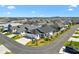 Overhead shot of neighborhood featuring grey roofs, green lawns and mature trees at 1674 Cadorette Dr, The Villages, FL 34762