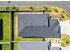 Aerial view of roof, manicured lawn, landscaping, and fenced backyard at 1674 Cadorette Dr, The Villages, FL 34762