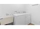Bright laundry room with sink, and modern white washer and dryer at 1674 Cadorette Dr, The Villages, FL 34762