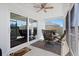 View of the covered screened patio and dining set visible through sliding glass door at 1674 Cadorette Dr, The Villages, FL 34762