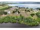 Scenic aerial view showcasing the property, surrounding neighborhood, and lake views at 17728 Palm View Cir, Mount Dora, FL 32757
