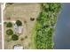 Aerial view of lakefront home surrounded by lush trees and beautiful waterfront at 17728 Palm View Cir, Mount Dora, FL 32757