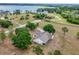 Aerial view of home with expansive lot, screened porch and mature trees at 17728 Palm View Cir, Mount Dora, FL 32757