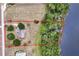 Aerial view of lakefront home with mature trees and a defined property line at 17728 Palm View Cir, Mount Dora, FL 32757