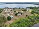 Aerial view of the house with a lake in the background at 17728 Palm View Cir, Mount Dora, FL 32757