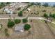 Aerial view of property with large lot, gray roof, and mature trees surrounding the home at 17728 Palm View Cir, Mount Dora, FL 32757