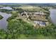 Wide aerial view showcasing multiple luxury homes with expansive, well-maintained lots and lake access at 17728 Palm View Cir, Mount Dora, FL 32757