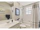 Well-lit bathroom with a shower-tub combo, white vanity, and neutral decor at 17728 Palm View Cir, Mount Dora, FL 32757