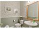 Charming bathroom with floral wallpaper, pedestal sink, and classic fixtures at 17728 Palm View Cir, Mount Dora, FL 32757