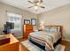 Bedroom with lots of natural light, wood floors, and comfortable furnishings at 17728 Palm View Cir, Mount Dora, FL 32757