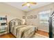 Cozy bedroom featuring a comfortable bed and wood floors at 17728 Palm View Cir, Mount Dora, FL 32757