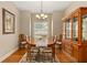 Traditional dining room with hardwood floors, a hutch, and a window providing ample natural light at 17728 Palm View Cir, Mount Dora, FL 32757