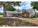 Charming single-Gathering home with brick accents, dormer windows, and a cozy front porch with white railing at 17728 Palm View Cir, Mount Dora, FL 32757
