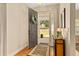 Welcoming foyer with hardwood floors and classic decor, leading into a bright and airy home at 17728 Palm View Cir, Mount Dora, FL 32757