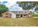 Charming single-story home with a brick facade, front porch, and well-manicured lawn at 17728 Palm View Cir, Mount Dora, FL 32757