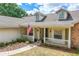 Charming home featuring a welcoming front porch adorned with an American flag, showcasing curb appeal and patriotic spirit at 17728 Palm View Cir, Mount Dora, FL 32757