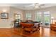 Spacious game room with a stylish pool table and natural light from French doors at 17728 Palm View Cir, Mount Dora, FL 32757