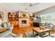 Cozy living room features a brick fireplace, built-in shelves, and large windows for natural light at 17728 Palm View Cir, Mount Dora, FL 32757