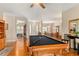Open floor plan showcasing the game room and dining area, connected by hardwood floors and neutral walls at 17728 Palm View Cir, Mount Dora, FL 32757