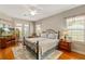 Comfortable main bedroom with a queen-sized bed, ensuite bath, and balcony access at 17728 Palm View Cir, Mount Dora, FL 32757