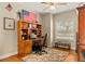 Inviting home office with hardwood floors, built-in desk, and natural light from a window at 17728 Palm View Cir, Mount Dora, FL 32757