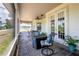 Screened-in patio with chairs, a table and a ceiling fan at 17728 Palm View Cir, Mount Dora, FL 32757