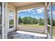 Lovely screened porch with tile floor and view of large green field at 17728 Palm View Cir, Mount Dora, FL 32757