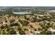 Aerial view of house and surrounding area with lakes and mature trees at 17825 Whisperwind Dr, Clermont, FL 34715