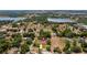 Aerial view of house and surrounding area with lakes and mature trees at 17825 Whisperwind Dr, Clermont, FL 34715