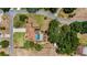 Aerial view of property featuring a private pool, mature trees, lush landscaping, and generous backyard space at 17825 Whisperwind Dr, Clermont, FL 34715