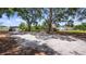Spacious backyard featuring mature trees, lush greenery, and ample room for outdoor activities and relaxation at 17825 Whisperwind Dr, Clermont, FL 34715