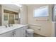This bright bathroom features white cabinets, double sinks, a shower and natural light at 17825 Whisperwind Dr, Clermont, FL 34715