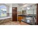 Bathroom features a walk-in shower and garden tub with a large window across from a granite topped vanity at 17825 Whisperwind Dr, Clermont, FL 34715