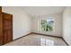 Well-lit bedroom offering tiled flooring, closet, and views from the window at 17825 Whisperwind Dr, Clermont, FL 34715