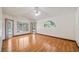 Spacious bedroom with hardwood floors, ceiling fan, and views of pool from the window at 17825 Whisperwind Dr, Clermont, FL 34715