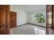 Bright bedroom with tile floors, featuring a window with natural light and a wood closet at 17825 Whisperwind Dr, Clermont, FL 34715